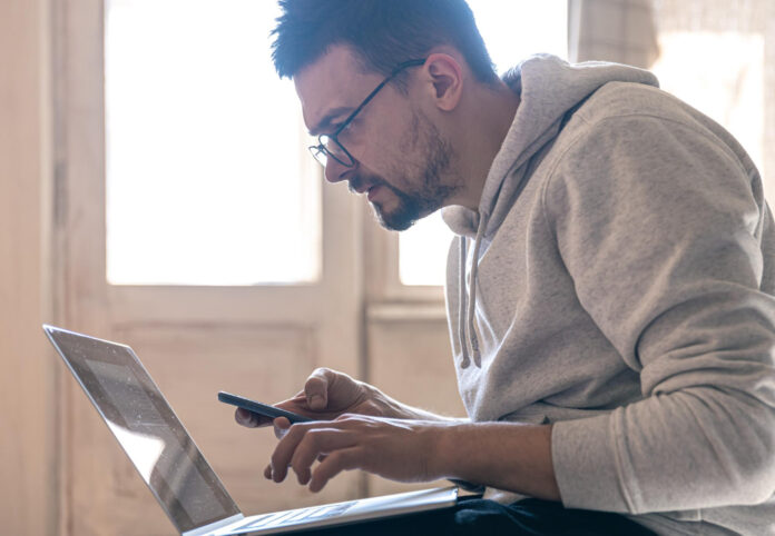 man-with-glasses-is-working-laptop